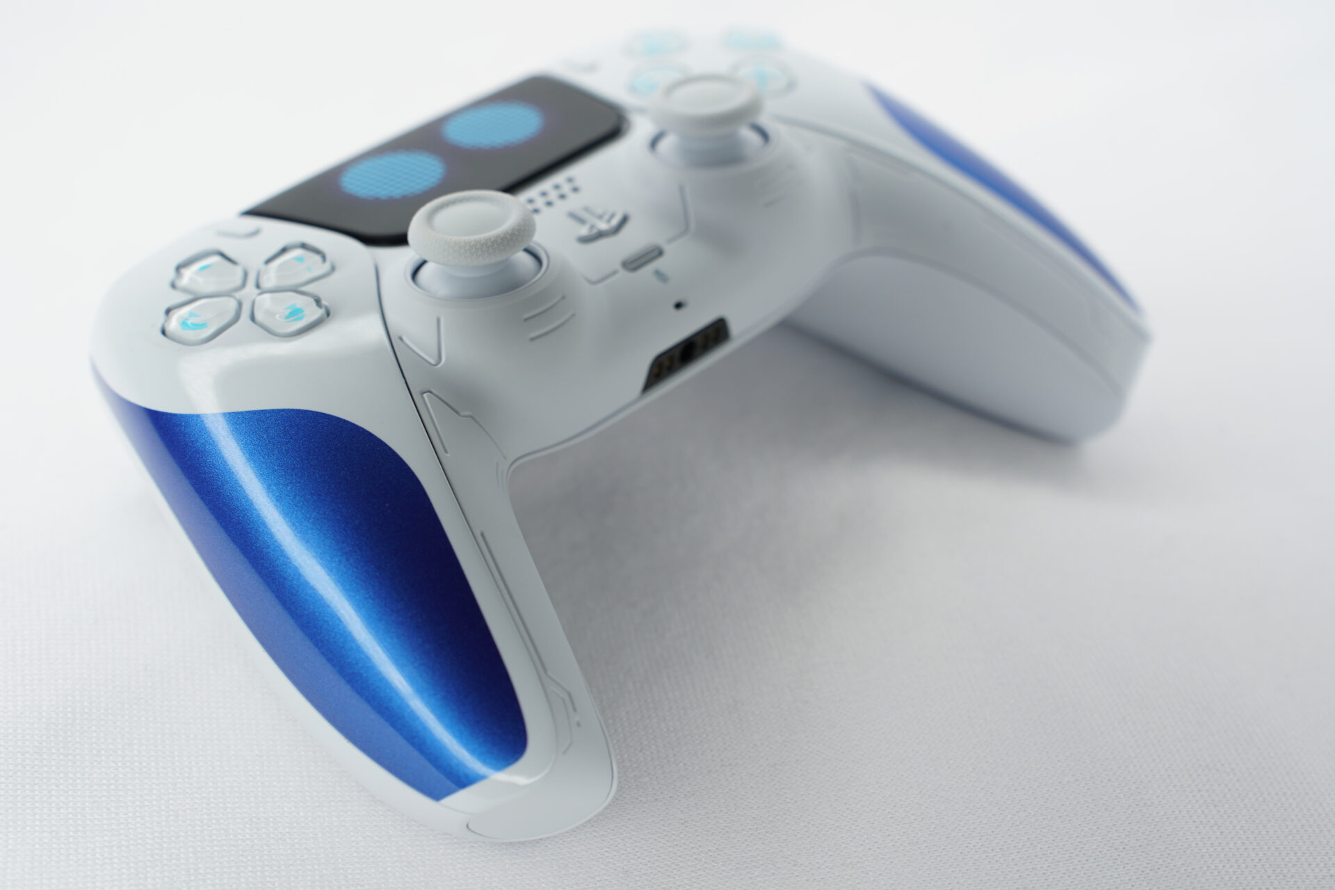 AstroBot PS5 Controller PS5 controller blue and white laying on a white surface.